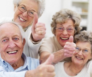 Group of older people showing thumbs up